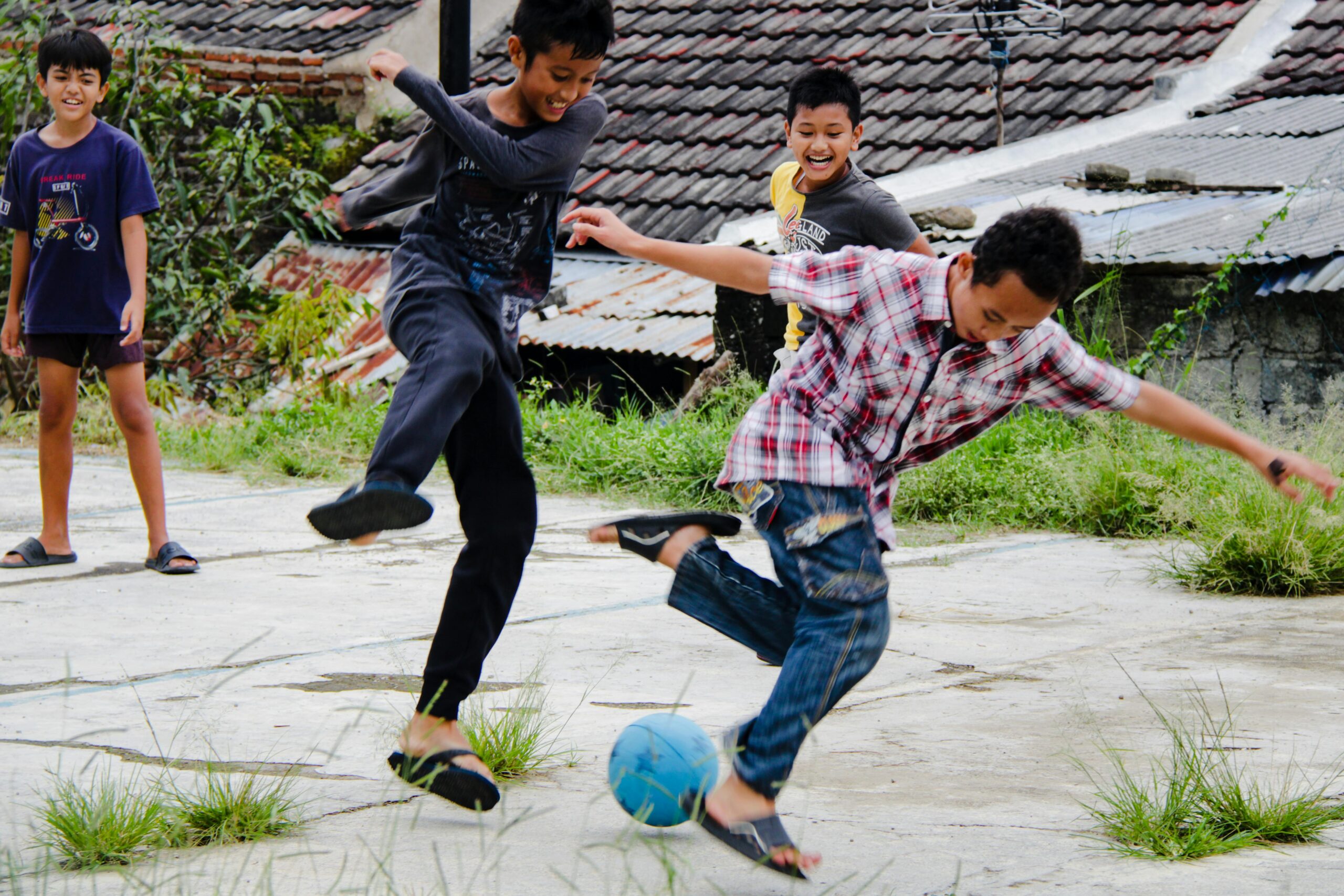 A group of boys playing soccer joyfully on a sunny day, capturing friendship and fun.